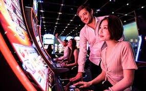 Mobile phone showing live casino interface with dealer